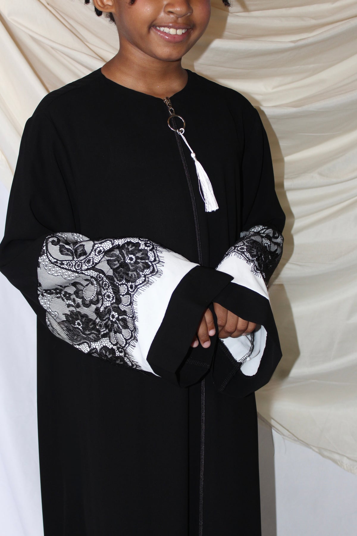 Amna kids abaya styled with a matching waist belt