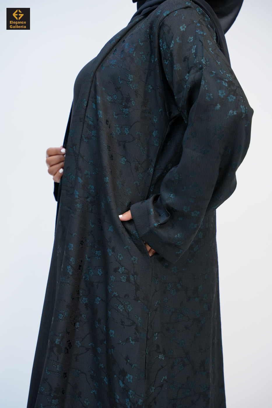 Close-up of the subtle floral texture on the open abaya coat